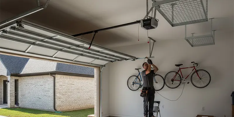 High-lift track system and wall-mount opener installed in a Dallas garage to free ceiling space